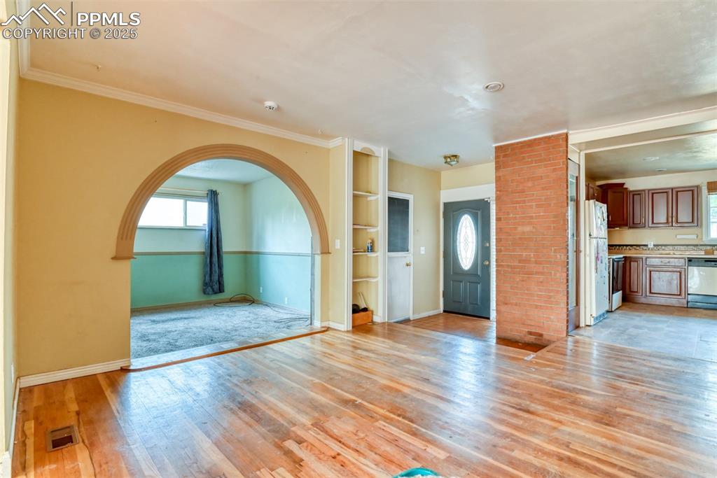 Image 21 of 44: Living room features real hard wood flooring