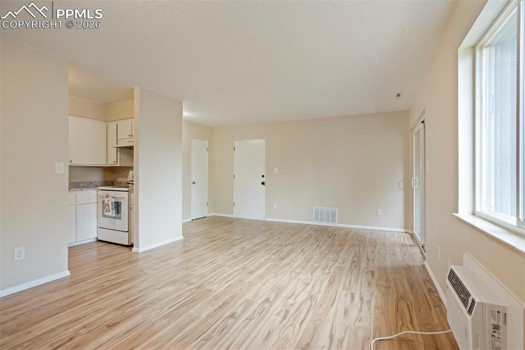 Image 2 of 25: View of front door leading into the living room.