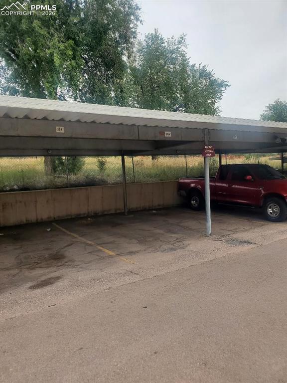 Image 25 of 25: Parking space in carport, close to front door of the unit.