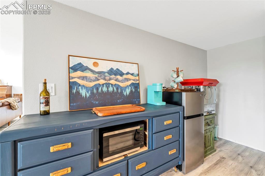 Image 25 of 50: This nook off the staircase provides a great space for a dry bar or snack c