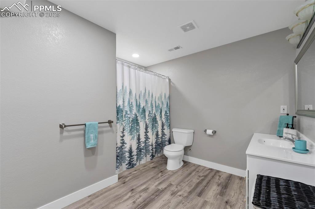 Image 27 of 50: The large full bath in the basement is located next to the bonus room.