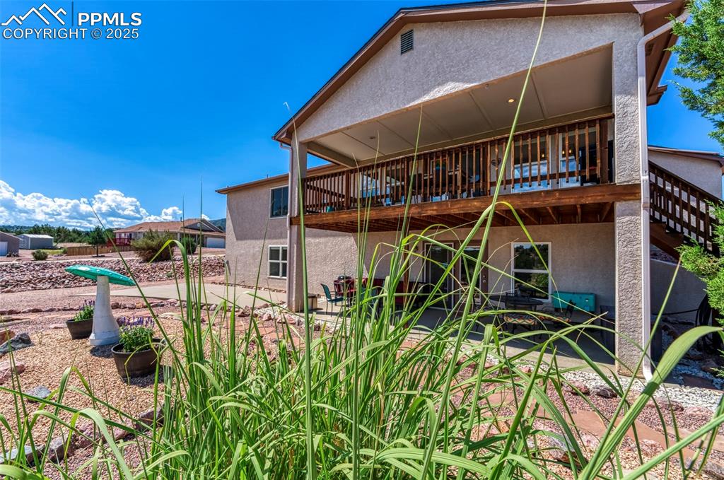 Image 33 of 50: A large RV pad and hookup is adjacent to the back patio.  A separate drivew