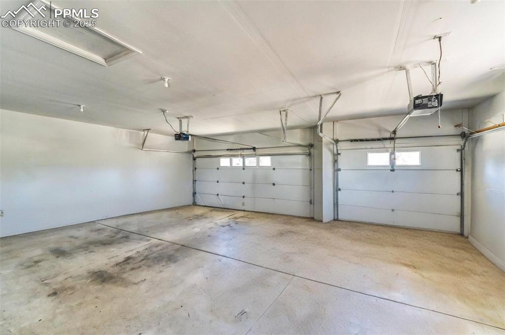 Image 35 of 50: The 3 car garage has 2 overhead doors. The smaller bay on the right is deep