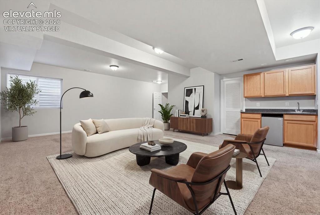 Image 32 of 44: basement rec— room with wet bar. Virtually staged