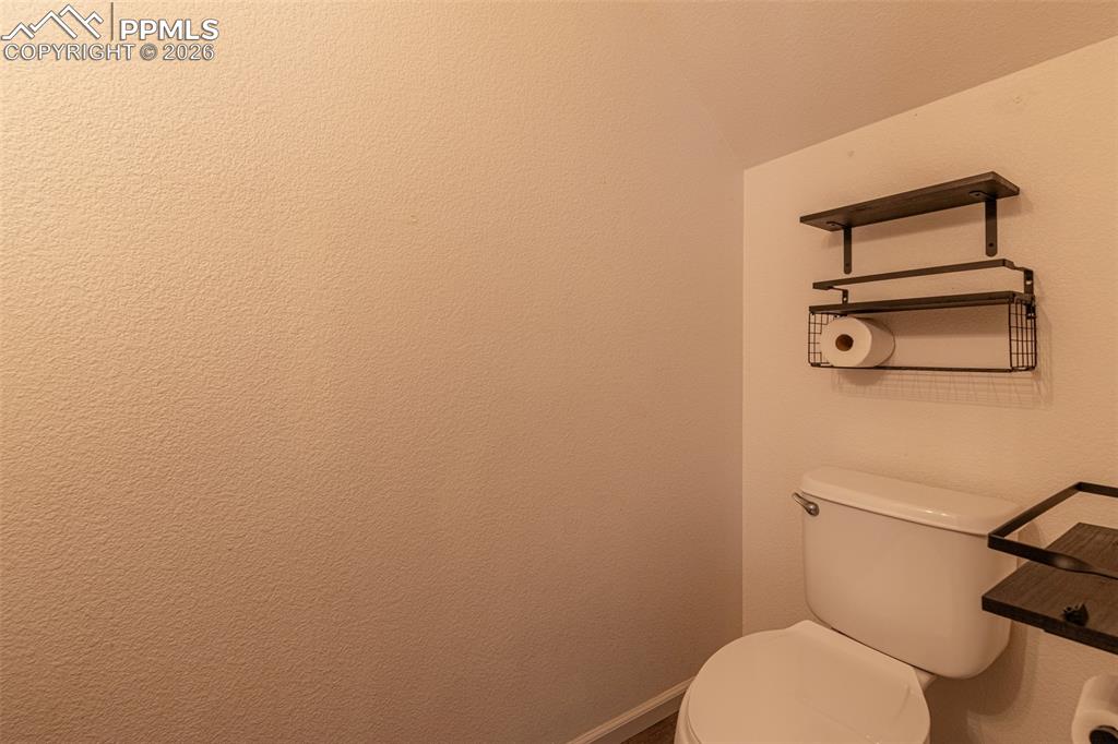 Image 17 of 34: Bathroom featuring toilet and baseboards