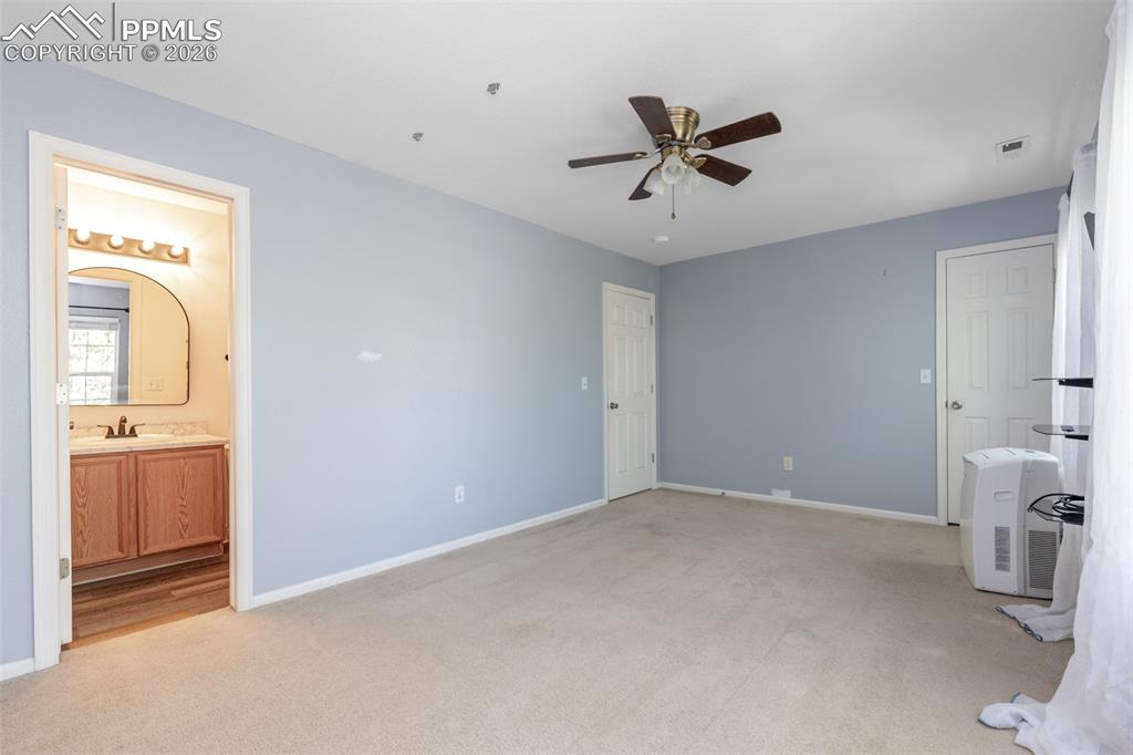 Image 23 of 34: Unfurnished bedroom featuring light colored carpet, a ceiling fan, and conn