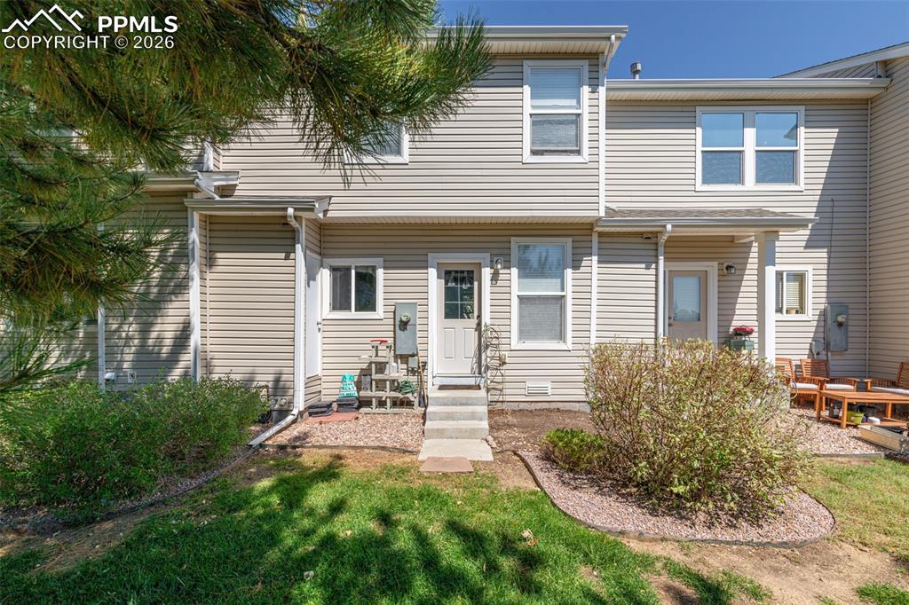 Image 27 of 34: Rear view of house with a yard