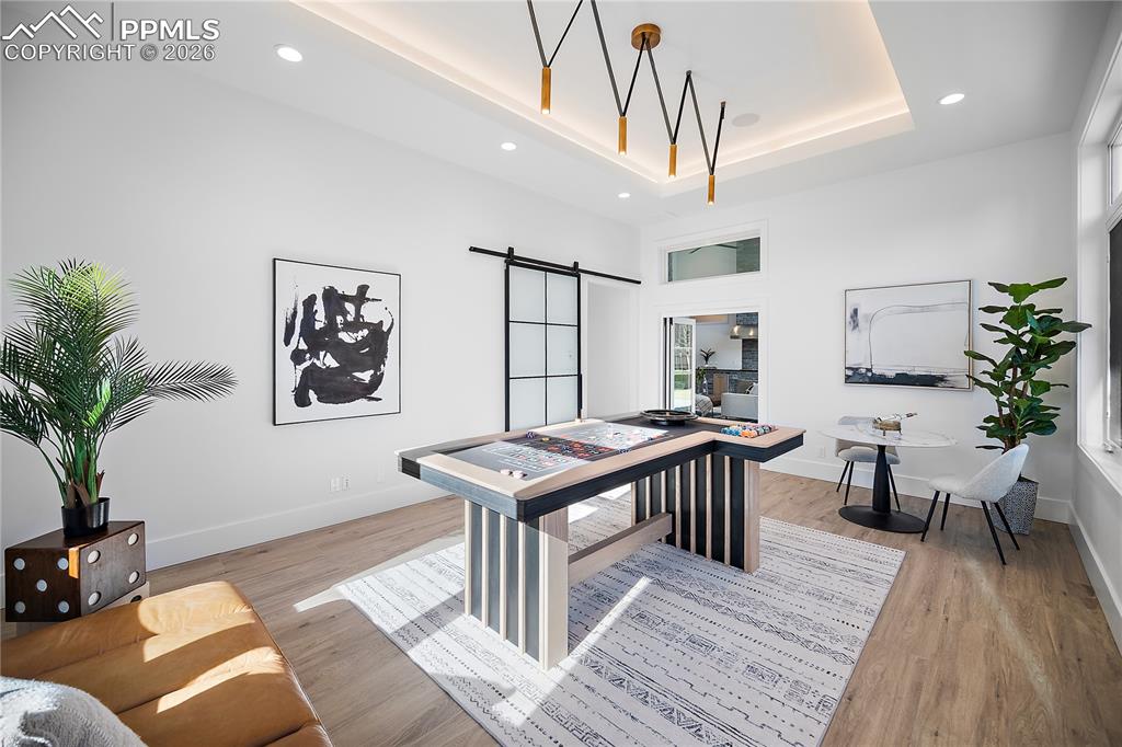 Image 15 of 43: A versatile game or bonus room that opens to the patio, perfect for enterta