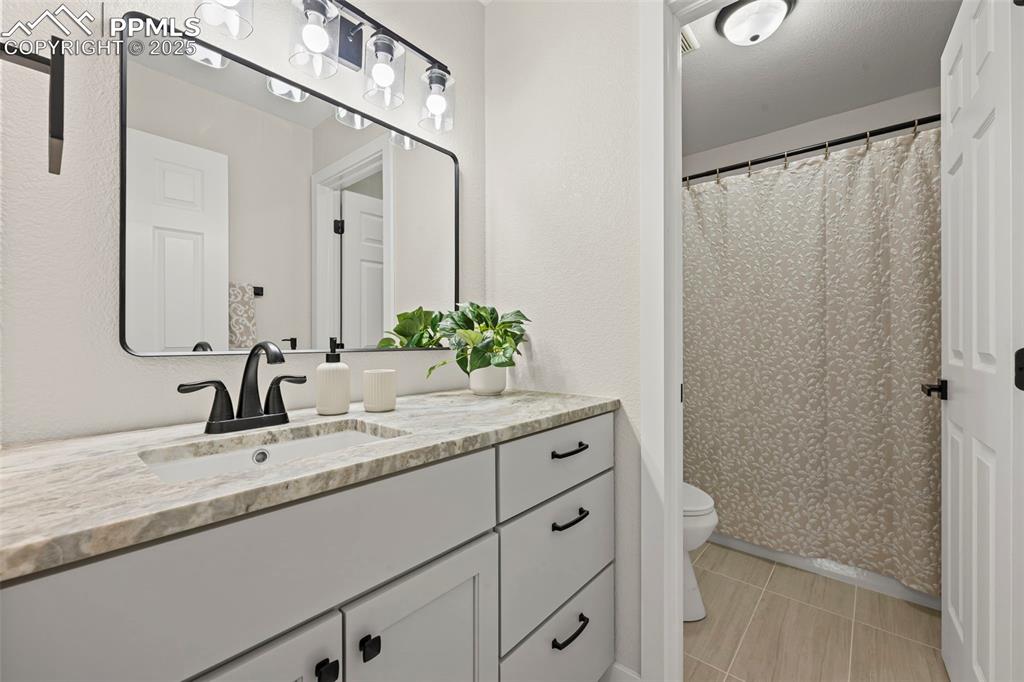 Image 19 of 48: Bathroom with vanity and tile patterned floors