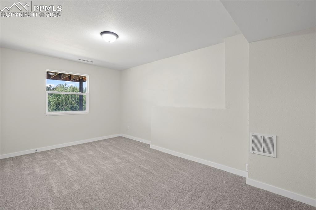Image 29 of 48: Empty room with carpet and baseboards