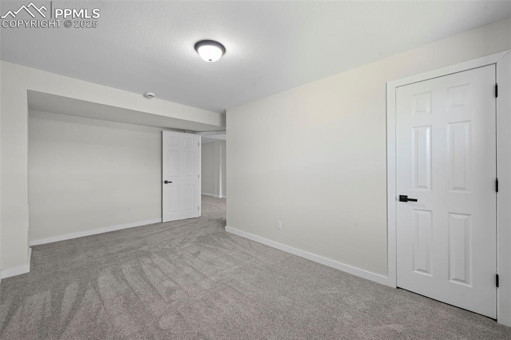 Image 30 of 48: Unfurnished bedroom featuring carpet and baseboards