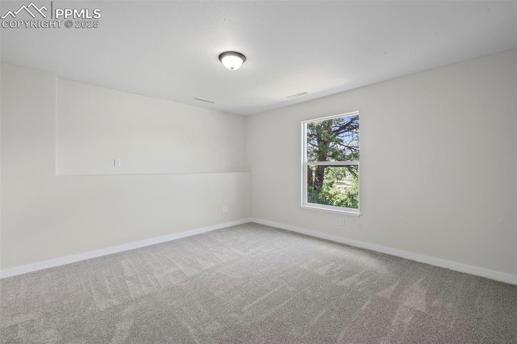 Image 31 of 48: Empty room featuring carpet floors