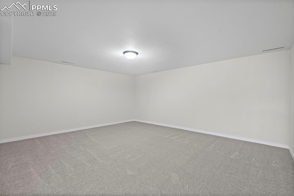 Image 34 of 48: Additional living space with carpet floors and baseboards