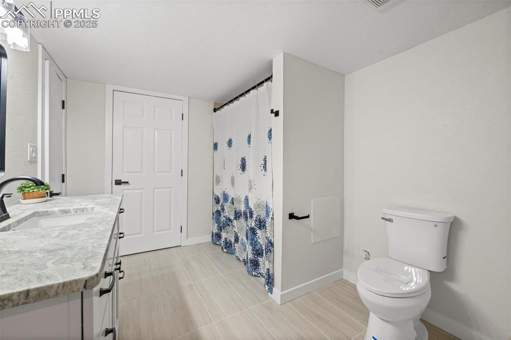 Image 40 of 48: Full bathroom with vanity and a shower with curtain