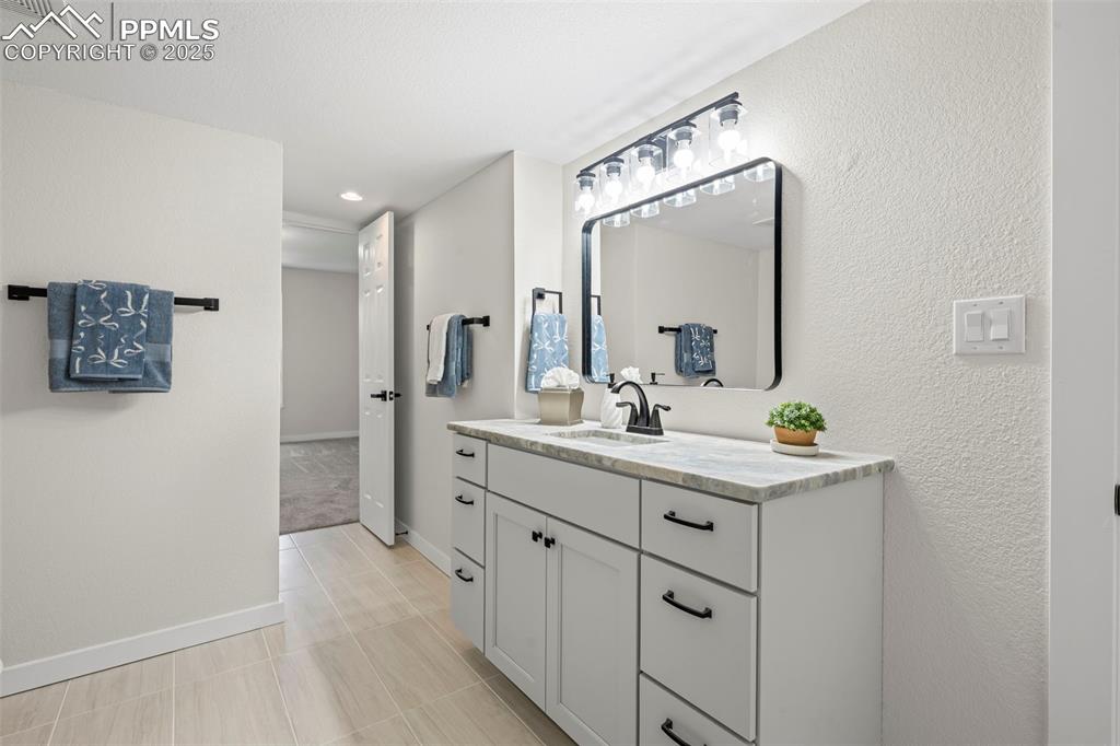 Image 41 of 48: Bathroom with vanity and recessed lighting