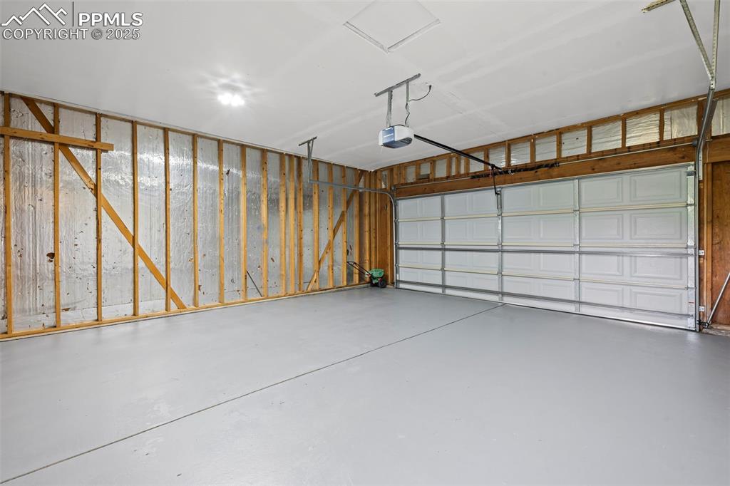 Image 45 of 48: Garage featuring a garage door opener