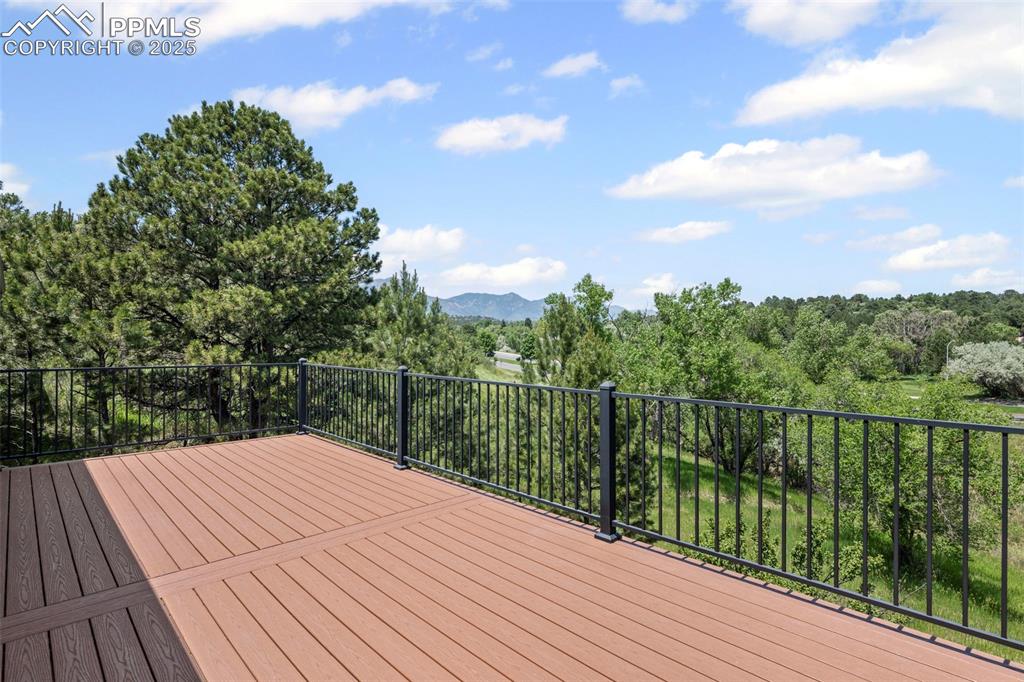 Image 47 of 48: Wooden terrace featuring a mountain view