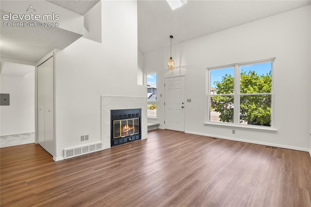 Image 3 of 33: High ceilings and gas fireplace with tile surround
