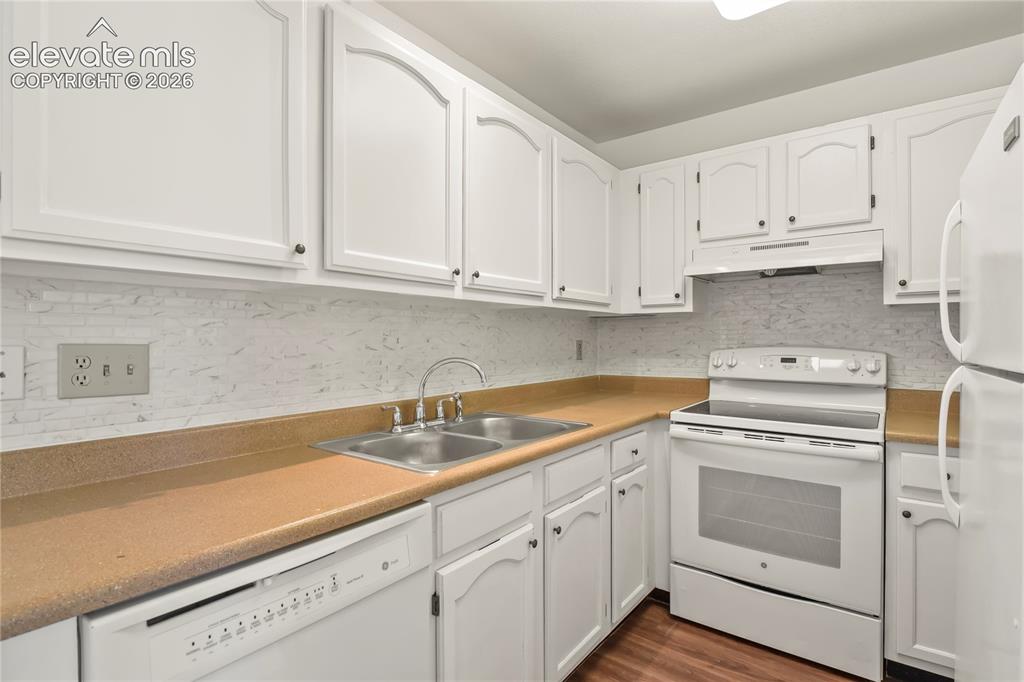 Image 5 of 33: Ample cabinet storage, tile backsplash, and an efficient layout