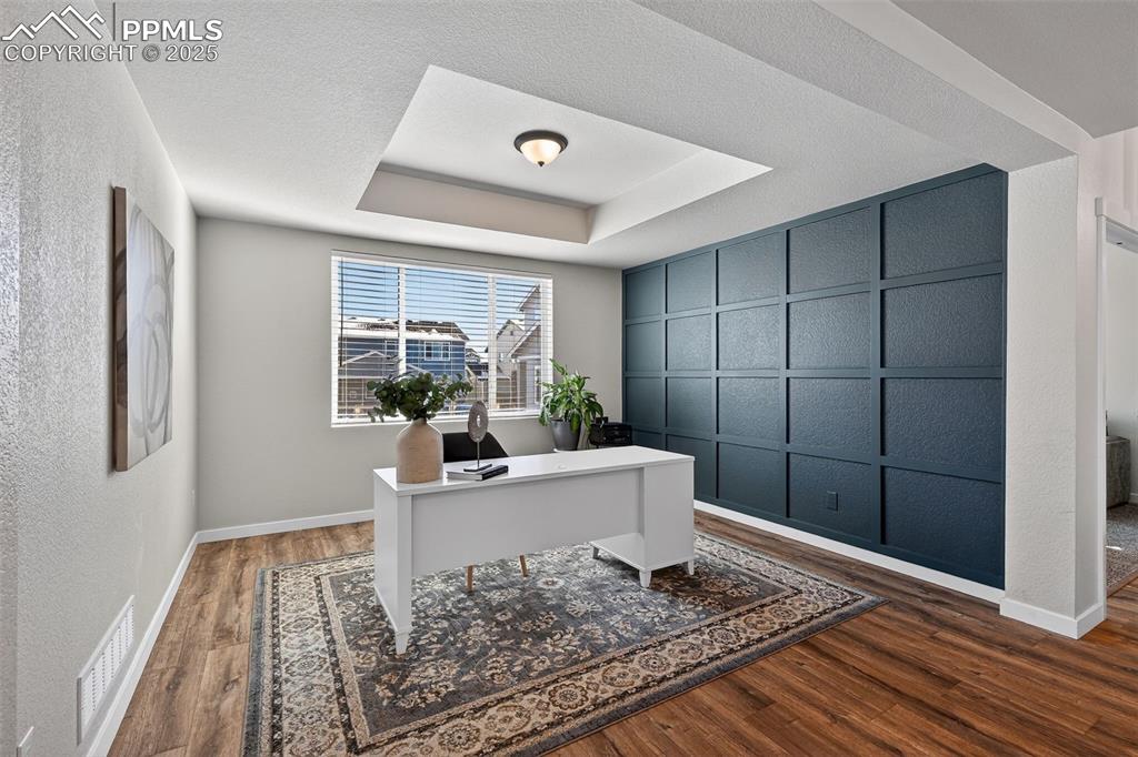Image 15 of 43: Office/Flex space with custom accent wall and detailed ceiling!