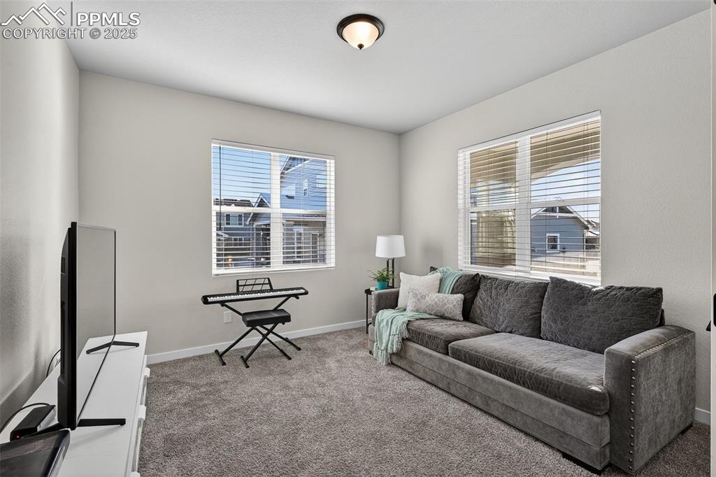 Image 16 of 43: Front room with large windows