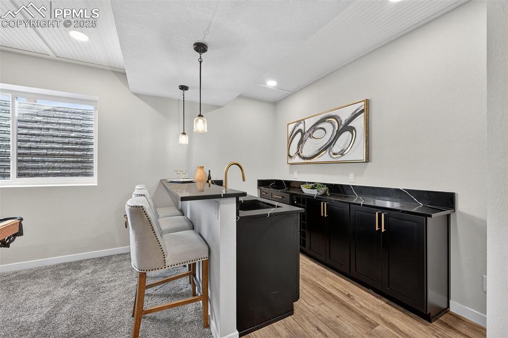 Image 32 of 43: Bar with seating and wine storage built-in!