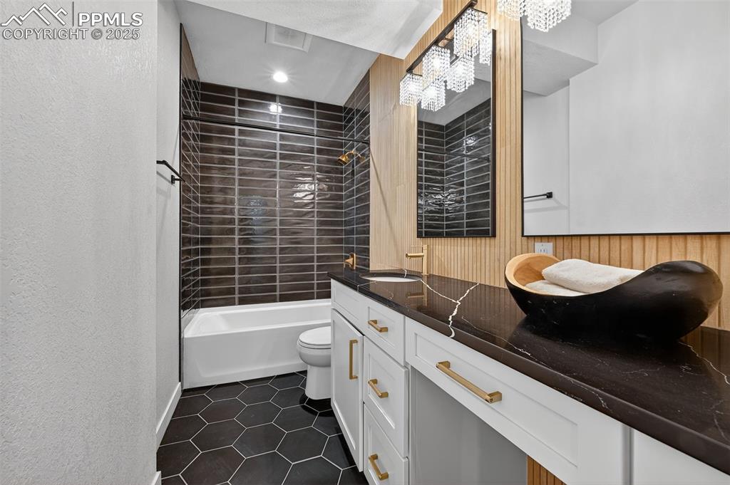 Image 36 of 43: Updated basement bath with vanity seating!