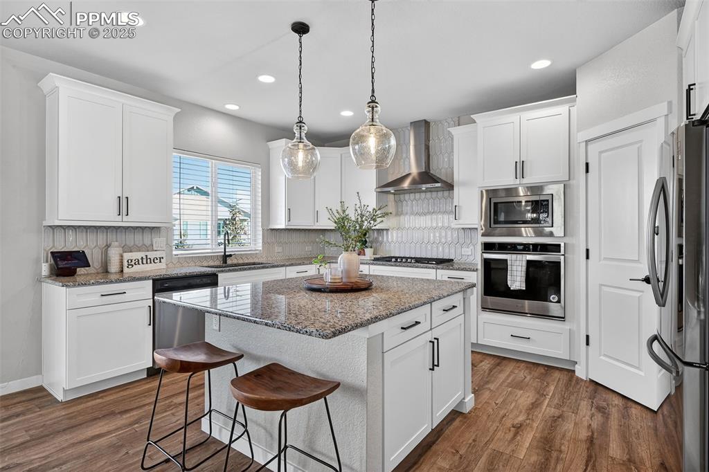 Image 6 of 43: Spacious white kitchen with center island
