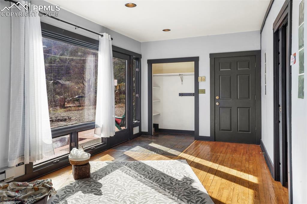 Image 32 of 47: Side entrance foyer/sunroom
with wood finished floors, slate tile floors a