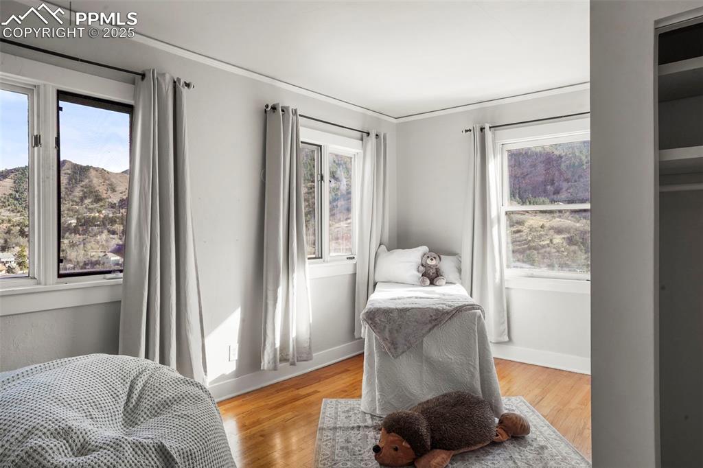 Image 45 of 47: 2 upstairs bedroom with wood floor and amazing views