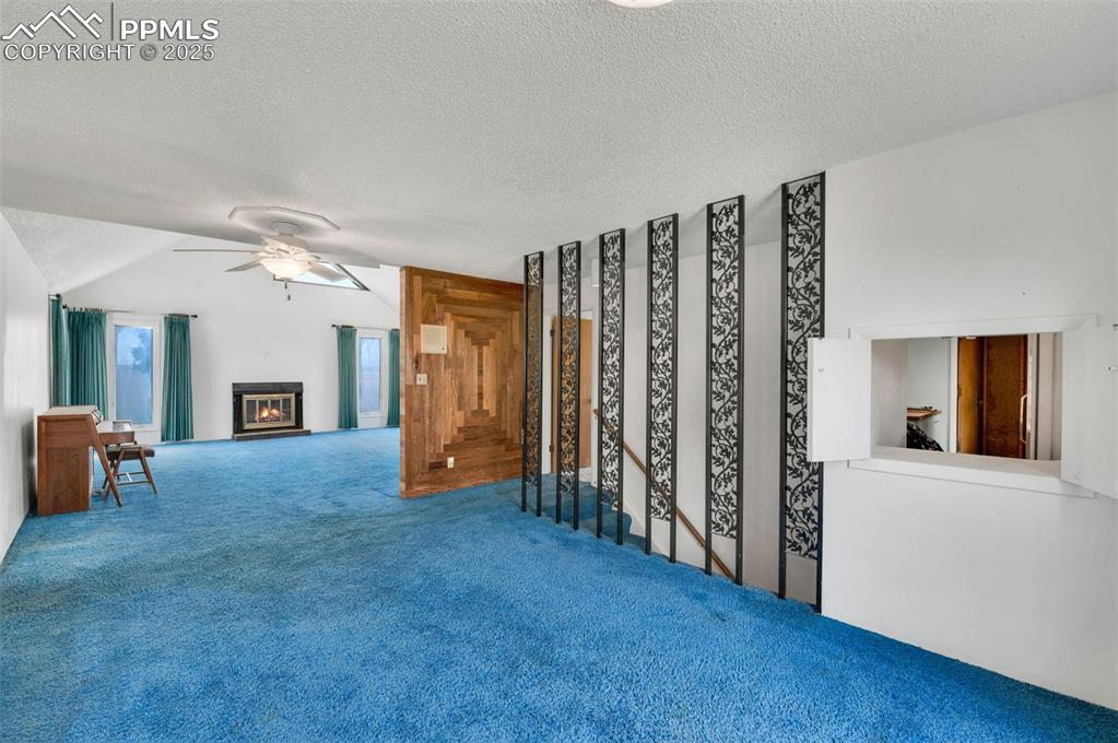 Image 12 of 50: dining room looking into the living room. stairs to the basement are on the