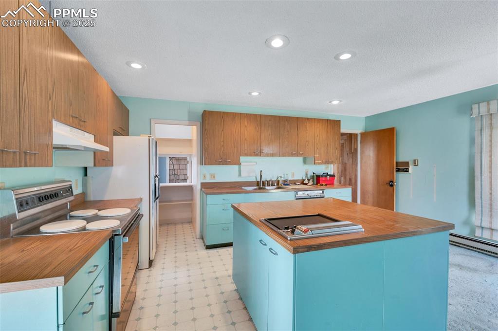 Image 14 of 50: The kitchen is elevated with classic St. Charles cabinetry. the 4