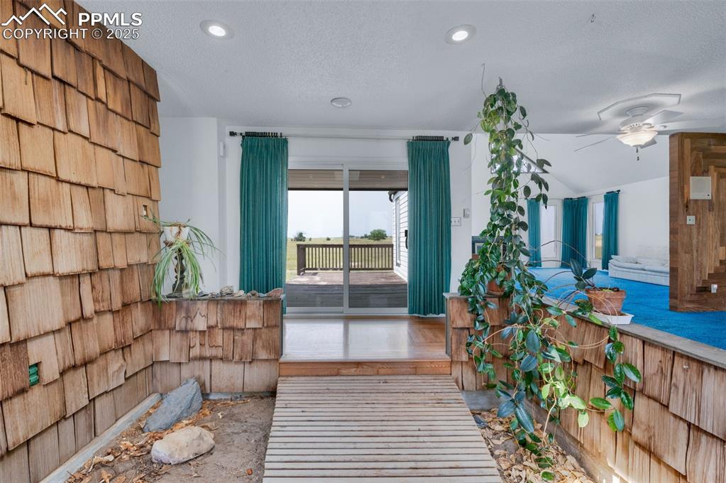 Image 6 of 50: The entry is designed to be an indoor garden. The bridge is a hard wood a f