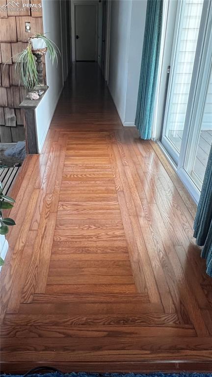 Image 7 of 50: Entry hard wood floor detail. On the left is the entry bridge, on the right