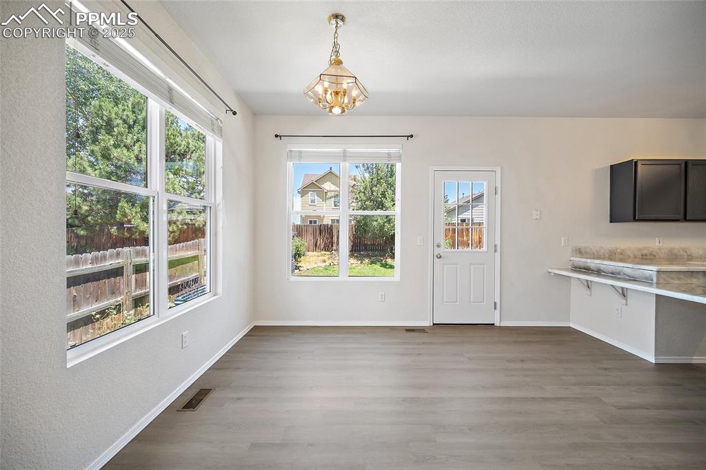 Image 11 of 46: Large area for a big family dinner table with walk out to the lush backyard