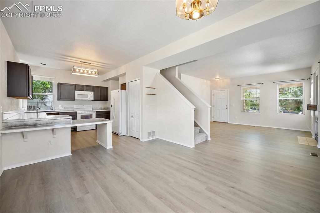 Image 12 of 46: Open kitchen with breakfast bar. 