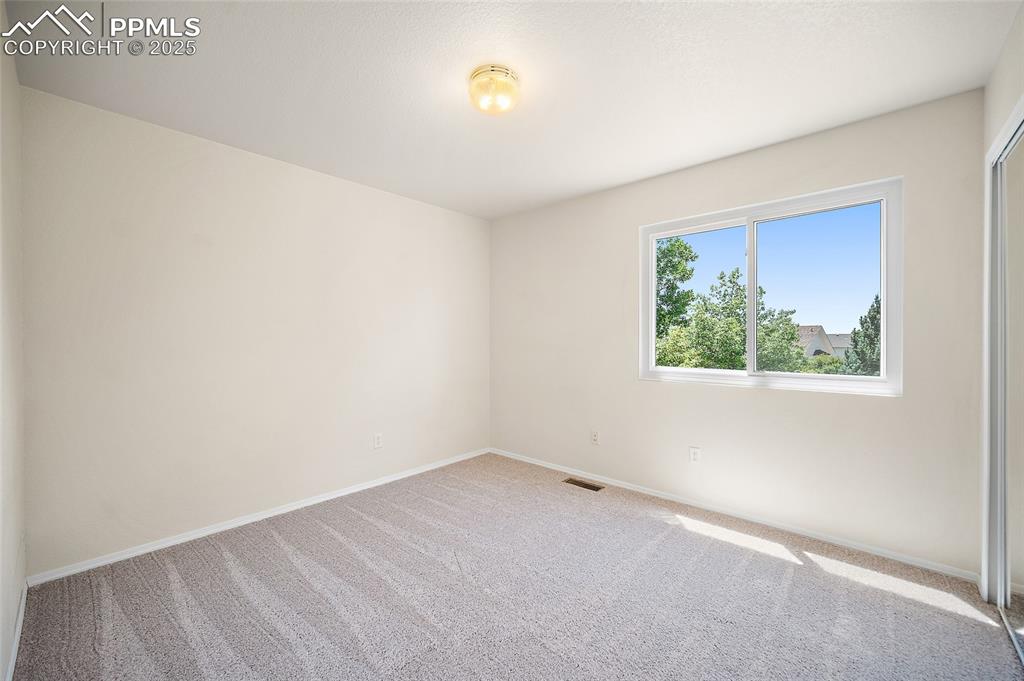 Image 20 of 46: Upper-level bedroom. 