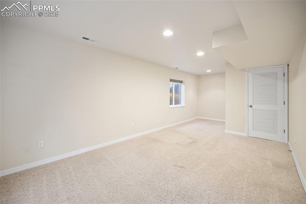 Image 35 of 46: Lower-Level recreation room or could be a 4th bedroom, workout room. 