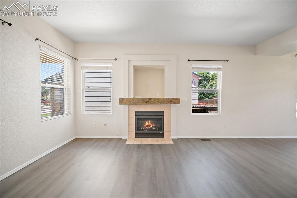Image 6 of 46: Gas fireplace in the living room. All blinds and rods. 