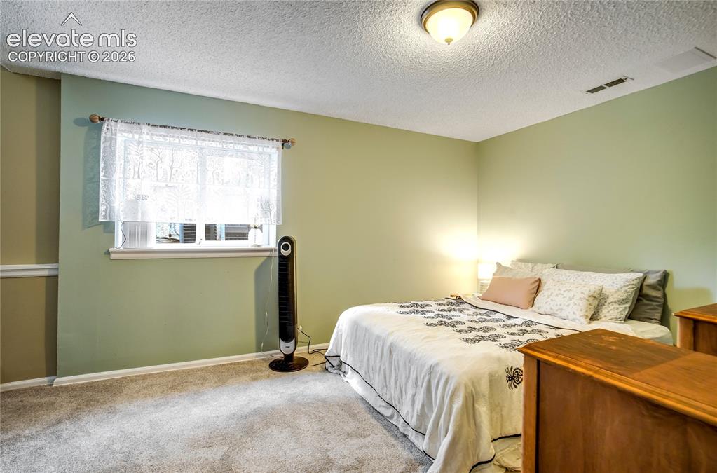 Image 17 of 50: Wall-to-wall carpeting and neutral wall tones