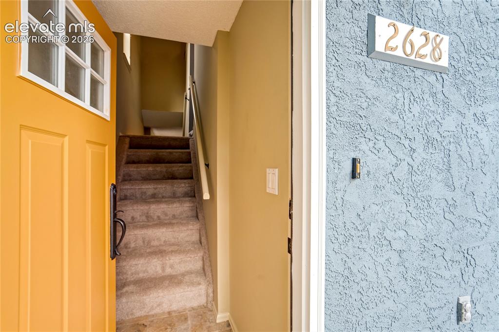 Image 28 of 50: Textured exterior finish with prominent address numbering