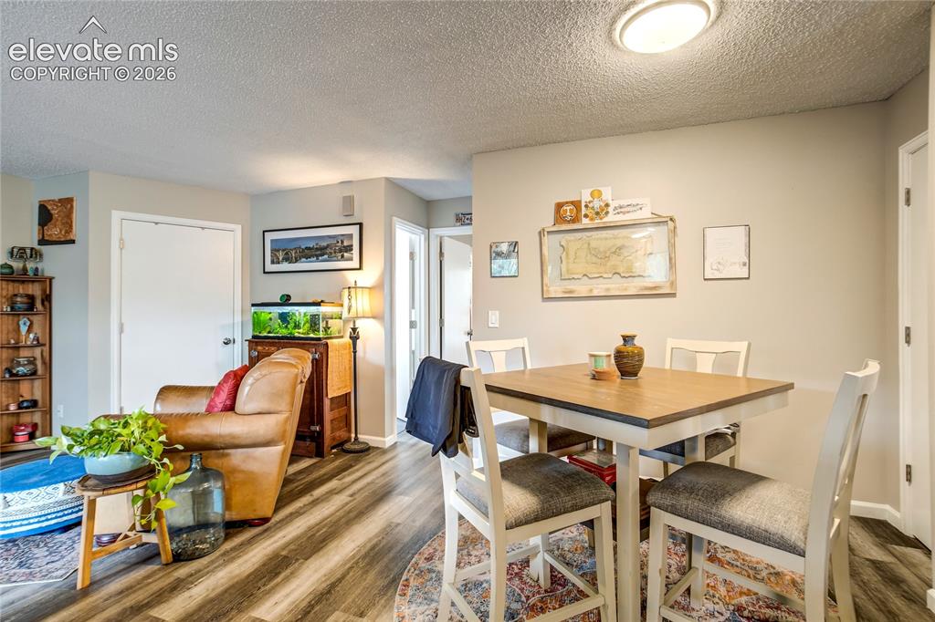 Image 35 of 50: Wood-finish flooring throughout, light neutral wall paint, and recessed cei