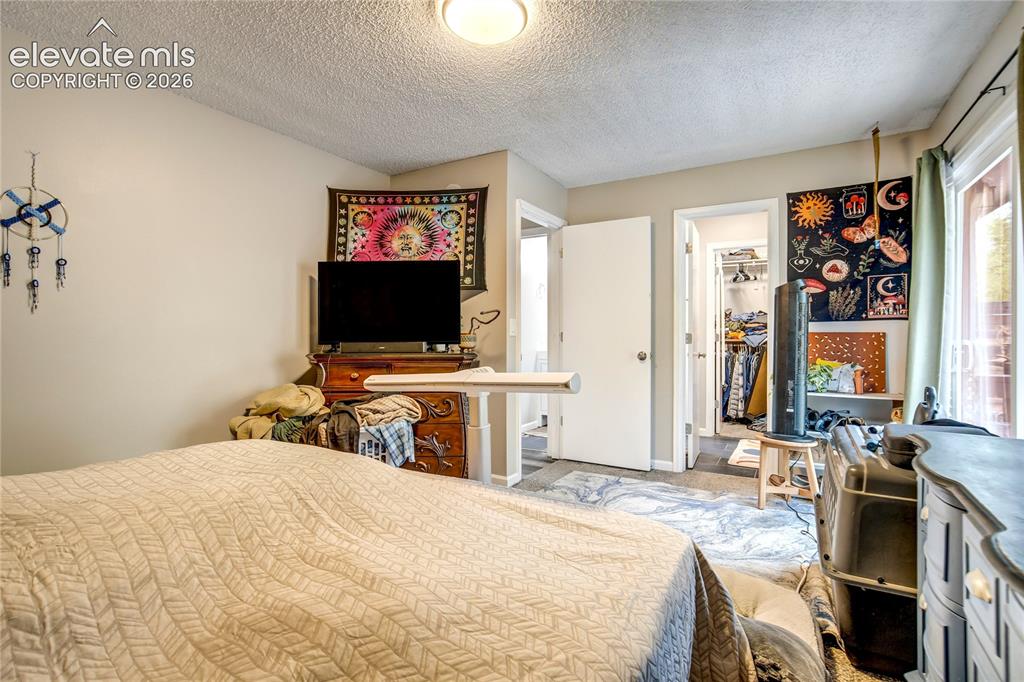 Image 38 of 50: Recessed lighting, light-colored walls, and textured ceiling