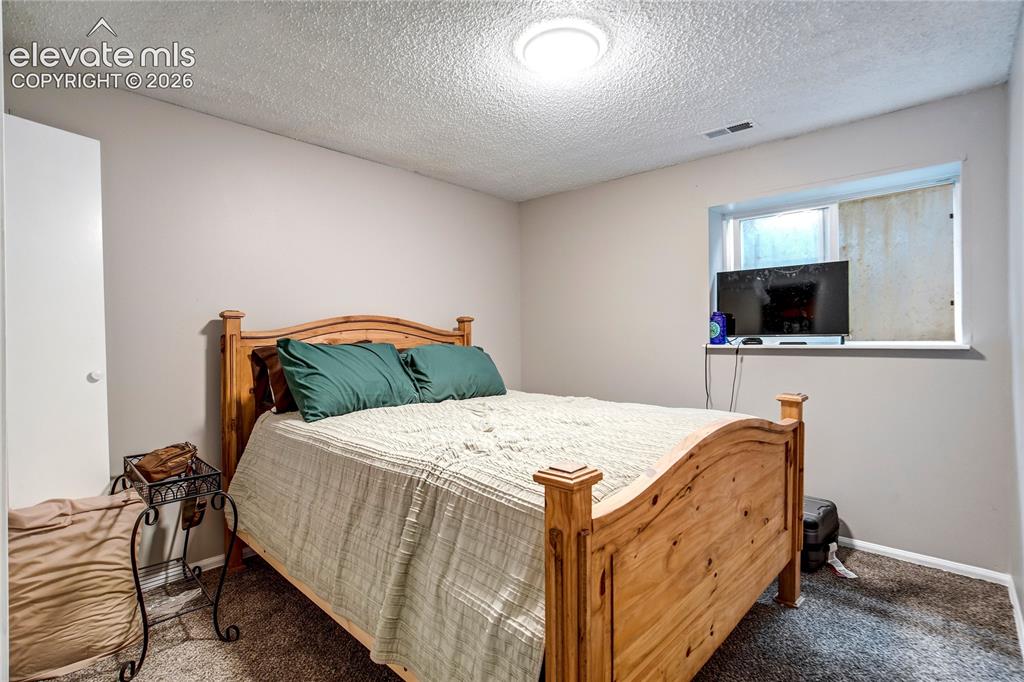Image 44 of 50: Recessed ceiling light, neutral wall paint, built-in window, and textured c