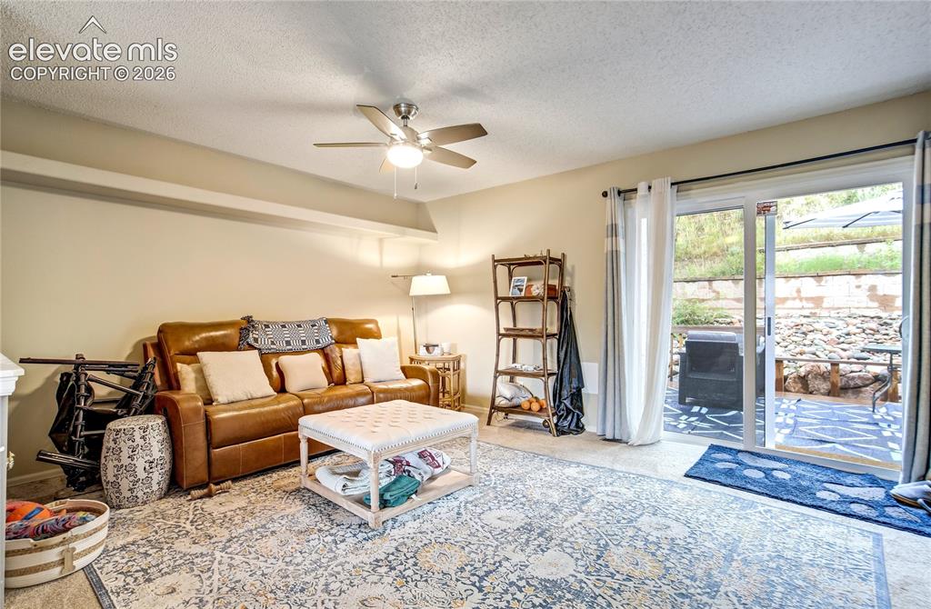 Image 5 of 50: Recessed ceiling lighting, ceiling fan, and sliding glass door to outdoor p