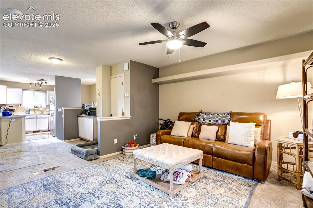 Image 6 of 50: Open-concept living area featuring a ceiling fan, recessed lighting, and a 