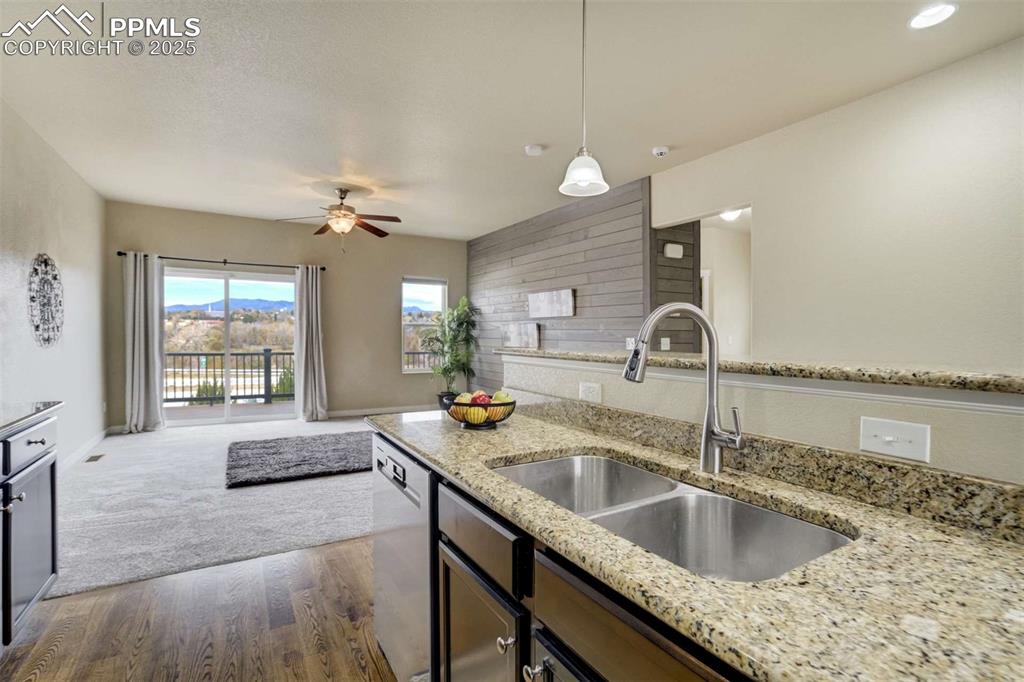 Image 16 of 50: Kitchen Sink & Bar Area – Granite countertops and a raised breakfast bar en