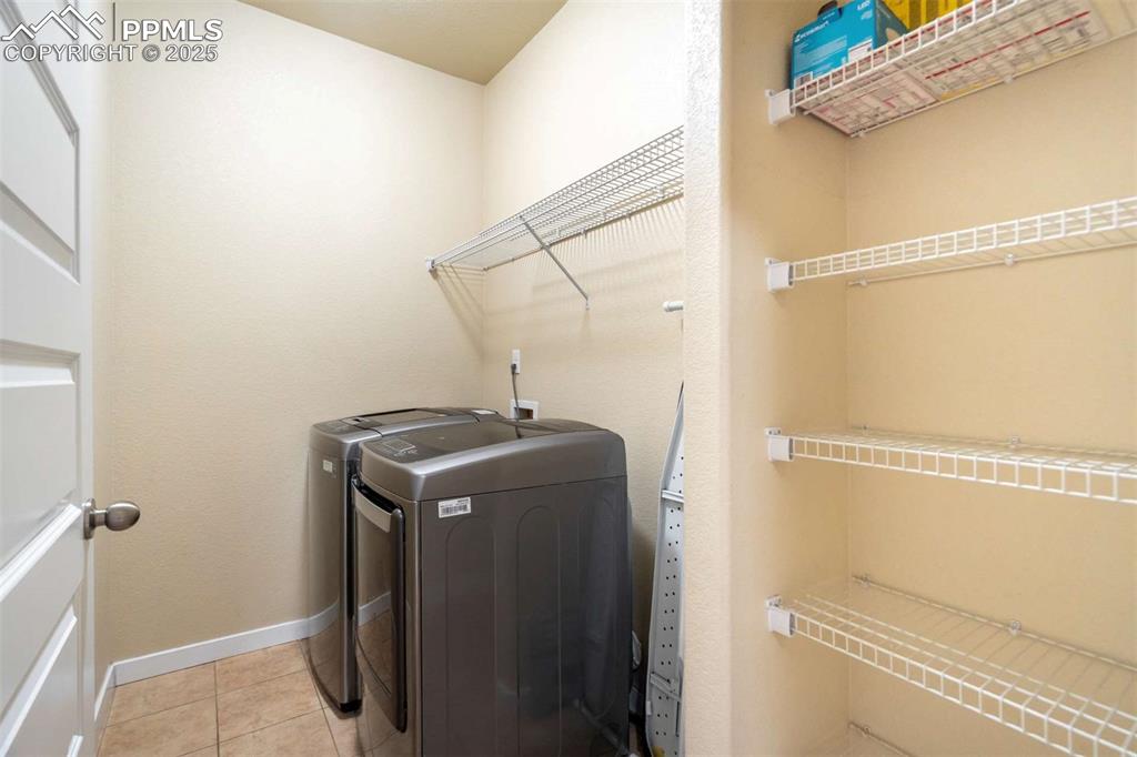 Image 21 of 50: Laundry Room – Dedicated laundry space with modern appliances, built-in she