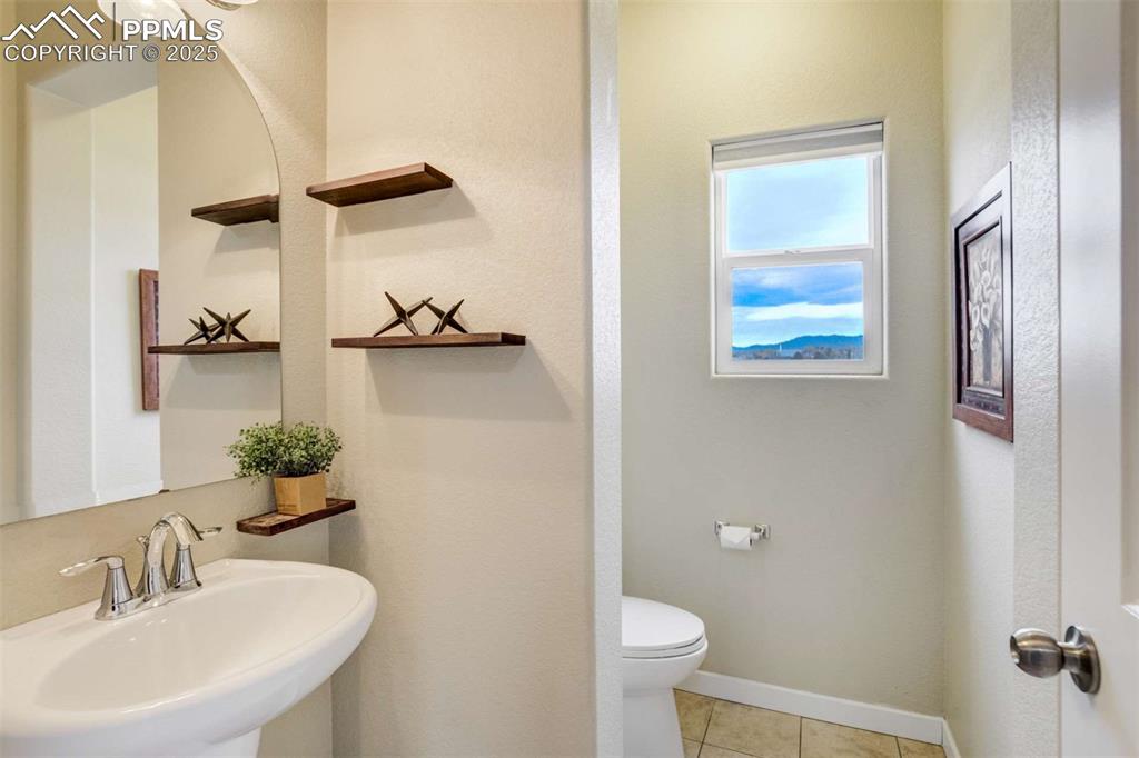 Image 22 of 50: Half Bath – Stylish main-level powder room featuring a pedestal sink, float