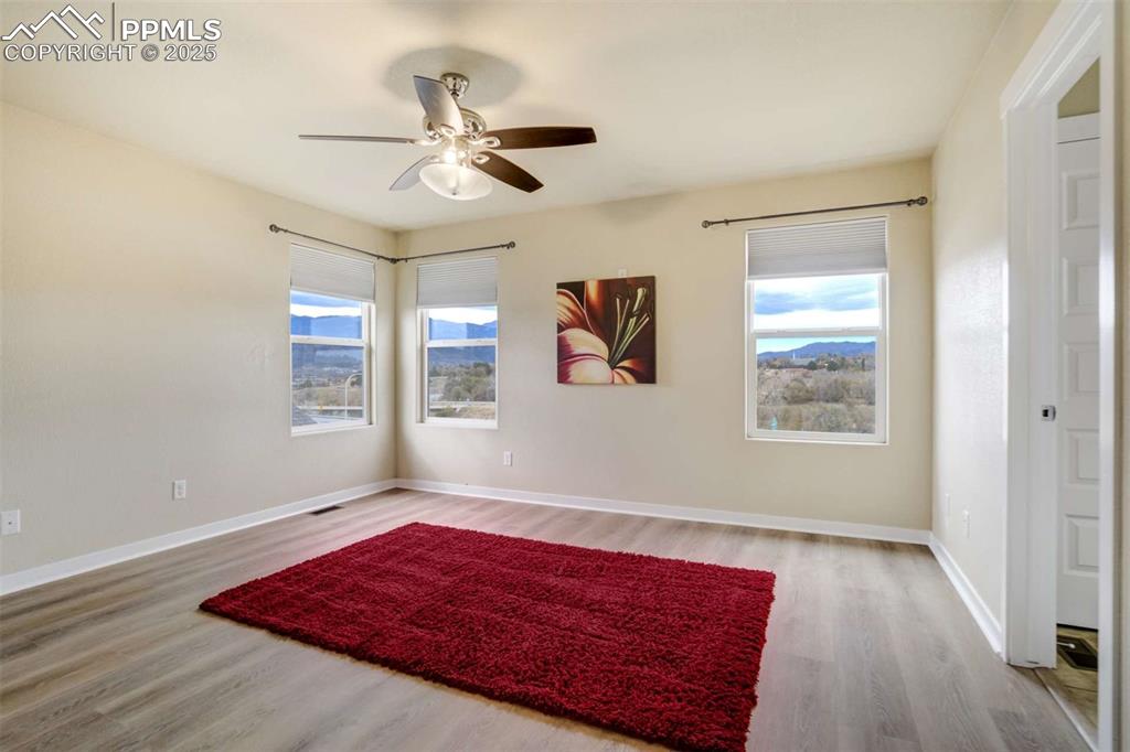 Image 24 of 50: Primary Bedroom – Spacious primary suite highlighted by multiple windows sh